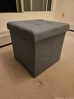 Full view of gray fabric storage ottoman cube