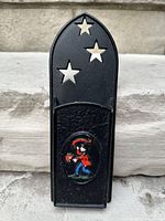 Full front view showing overall shape, star cutouts, figural panel