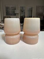 Front view of both glass votive holders side by side