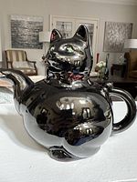 Front three-quarter view of black cat teapot