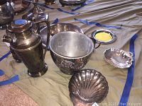Photo showing all silver plated items including the teapot, ice bucket, chip and dip dish, shell-shaped bowls, and a small round dish.