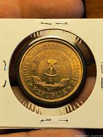 Obverse with hammer-and-compass emblem and inscription