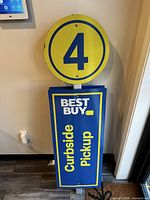 Full view of freestanding Best Buy curbside pickup sign showing number 4 circle and rectangular panel