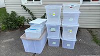 Group shot of all clear plastic bins stacked outdoors