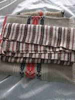 Both folded table runners showing stripe patterns