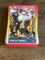 Stack of 1990 Score rookie football cards, top card Renaldo Turnbull