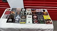 Full layout of approximately 30 CDs in jewel cases