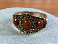 Front view showing three oval carnelian stones and ornate silver work