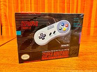 Front of sealed retail box showing InterAct Superpad Controller licensed for SNES