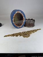 All three items: blue hat box, silver filigree holder, gold applique