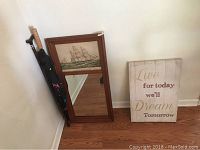 Photo showing the nautical-themed mirror, inspirational canvas, umbrella, and cane all together against a wall.