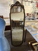 Full view of tall ornate mirror