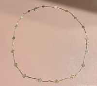 Full circular view of necklace showing overall length and station pattern