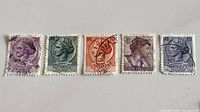 Front view of all five stamps showing denominations and overall condition