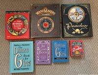 All seven books front covers visible