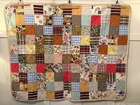 front view of entire handmade multicolor patchwork quilt