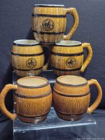 Group shot of five barrel-shaped mugs