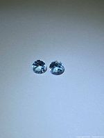 Pair of blue topaz gemstones side-by-side