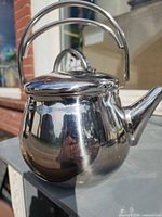Left front view of Lagostina stainless steel kettle showing body, spout, handle and lid