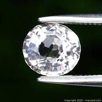 Oval faceted very light pink morganite held by tweezers showing cut and clarity