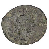 Obverse side of coin showing worn and corroded surface