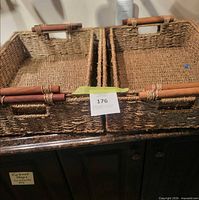 Two large woven baskets side by side, one containing two smaller nested baskets