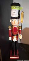 Full view of wooden nutcracker soldier on base