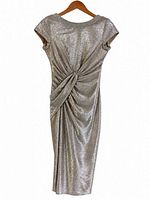Back view of metallic gold sheath dress showing gathered knot drape detail