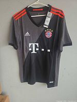 Front view of Adidas FC Bayern München jersey showing design, logos, and tags