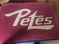 Maroon Peterborough Petes logo area rug showing full design