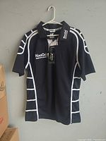 Front view of Kooga rugby shirt on hanger showing full design