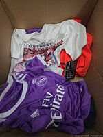 Purple Real Madrid Adidas jersey, Montreal Canadiens tee, red garment in box