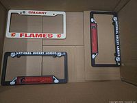 Four license plate frames including Calgary Flames and NHL generic