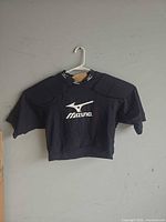 Front view of Mizuno padded compression shirt on hanger