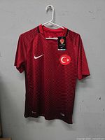 Full front view of Nike Turkey soccer jersey on hanger