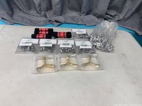 Entire lot laid out: sealed stud packs, loose studs bag, boot laces, wrenches