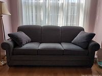 Front view of La-Z-Boy blue-gray sofa with two throw pillows