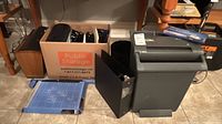 Entire lot: shredder, paper cutter, box with binders/folders, magazine holder, trash bin