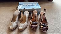 Both pairs of espadrille wedge shoes side by side with Sperry box