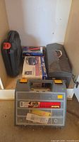 Lot overview showing organizer, inflator box, plastic and metal cases