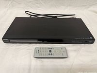 Front view of Philips DVP5982 DVD player with remote and power cord