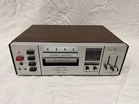 Front and top view of the Sears 8-track deck showing controls and woodgrain cabinet