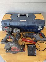 Full lot: four Porter Cable cordless power tools, charger, battery pack, spare blade, Irwin toolbox