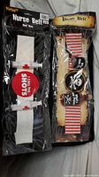 Both packaged belts side by side displaying branding