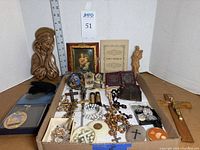 Overview of lot showing carved Mary plaque, framed picture, tray of devotional items