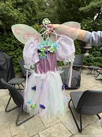 Front view of fairy costume on hanger showing dress, wings and headband