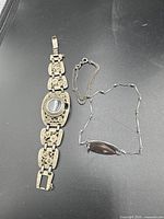 Both bracelets laid out on black surface