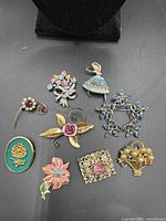 Group shot of all nine brooches showing overall condition and motifs