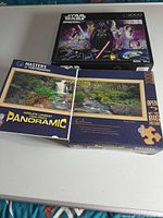 Both puzzle boxes: Star Wars 2000-piece and Broken Falls 1000-piece