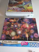 Fronts of both puzzle boxes showing artwork and 1500-piece labeling